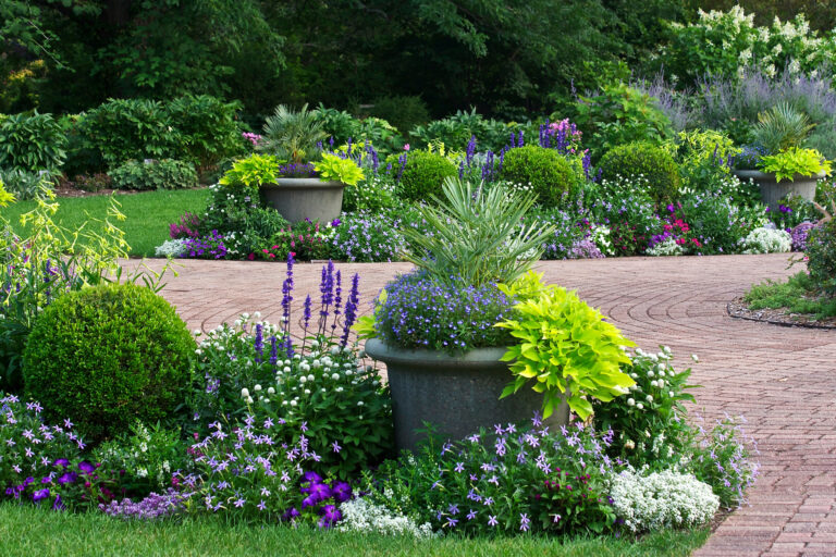 A path in a beautiful natural landscaped flower garden.